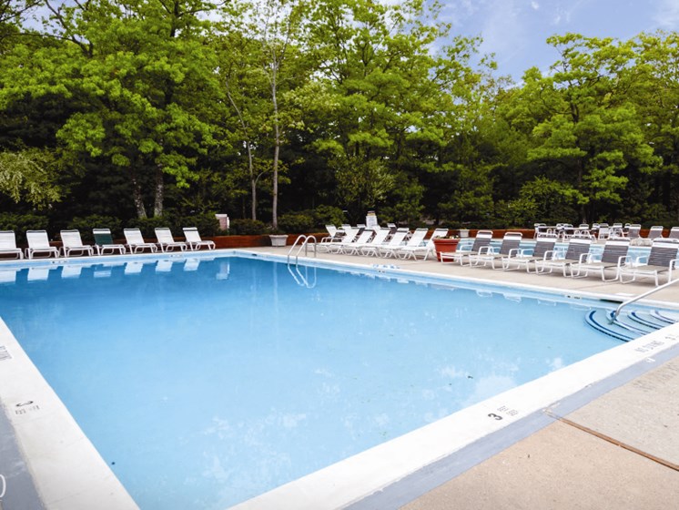 outdoor adult pool with clear blue water at Town & Country Luxury Apartments, Hampton Bays, NY, 11946